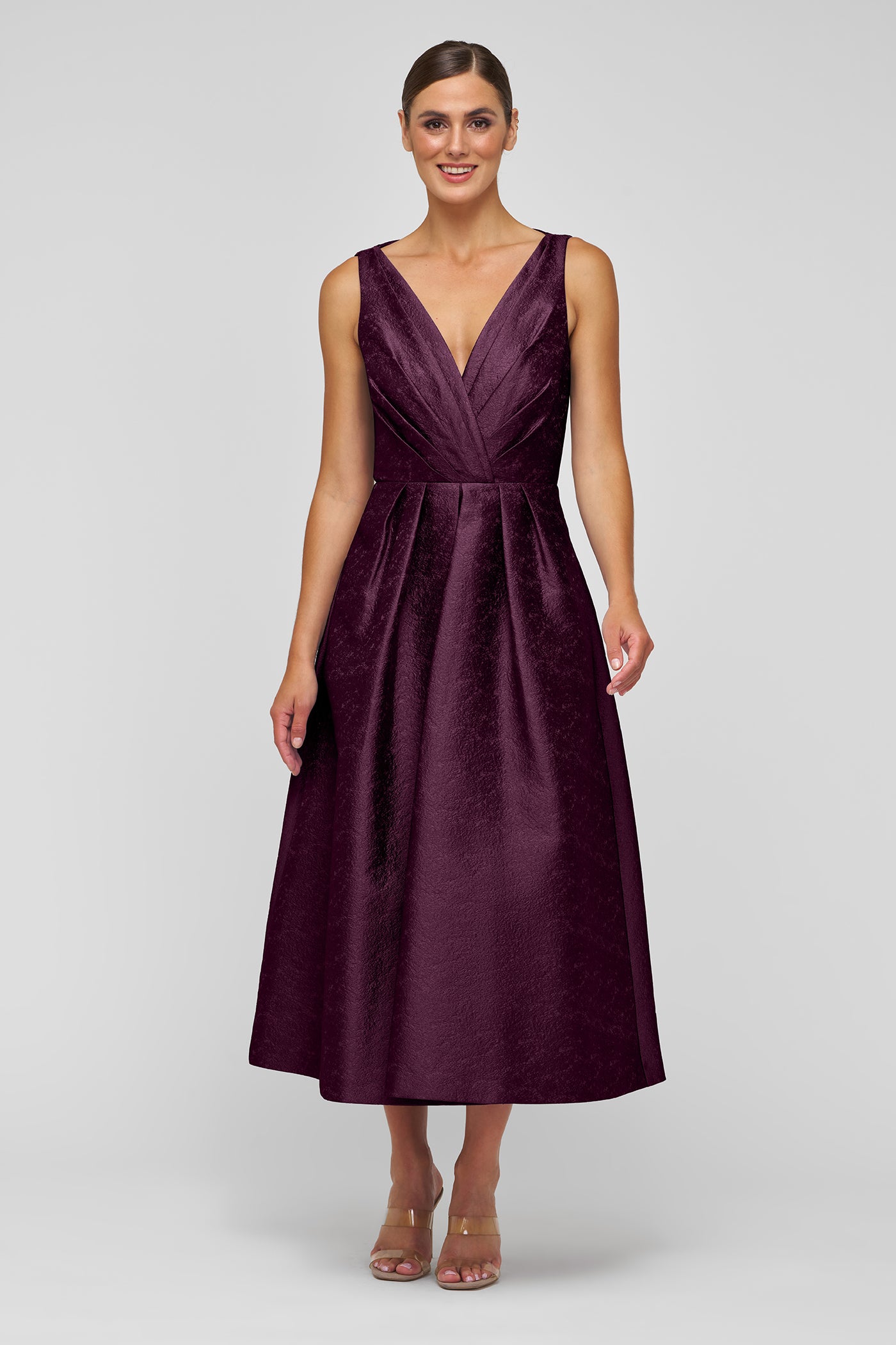 Woman wearing a purple dress on a white background