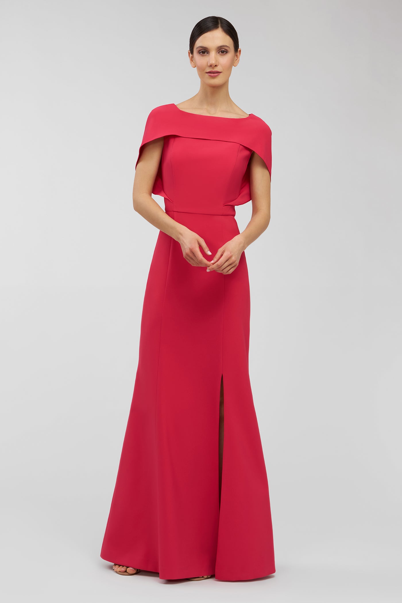 Woman wearing a pink evening gown on a white background
