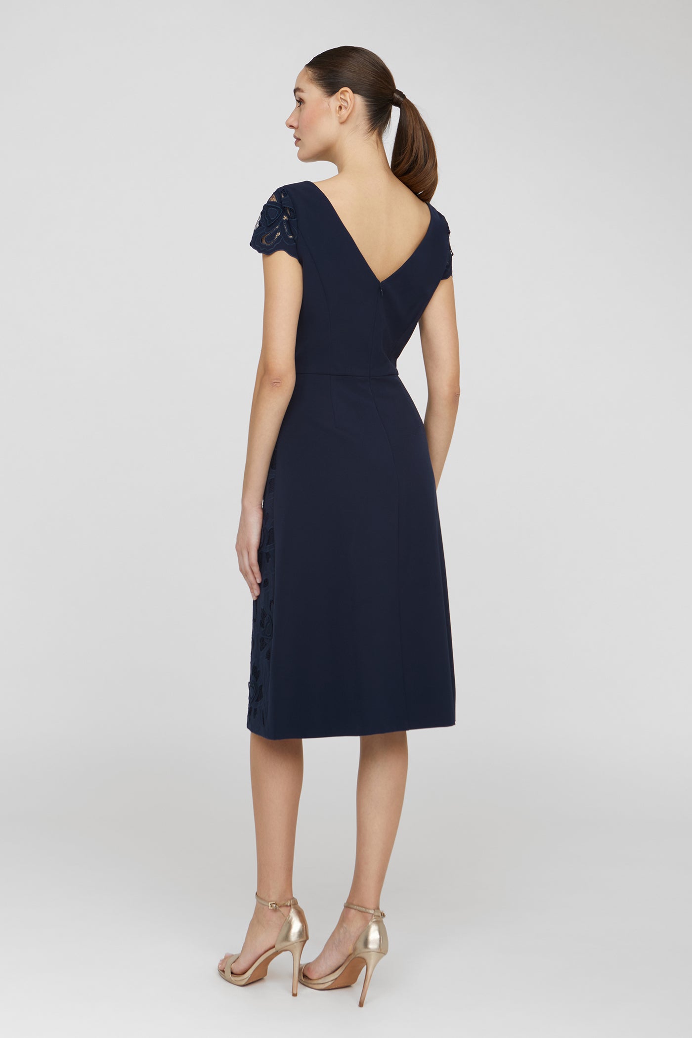 Navy blue dress with cap sleeves and a V-neckline on a white background