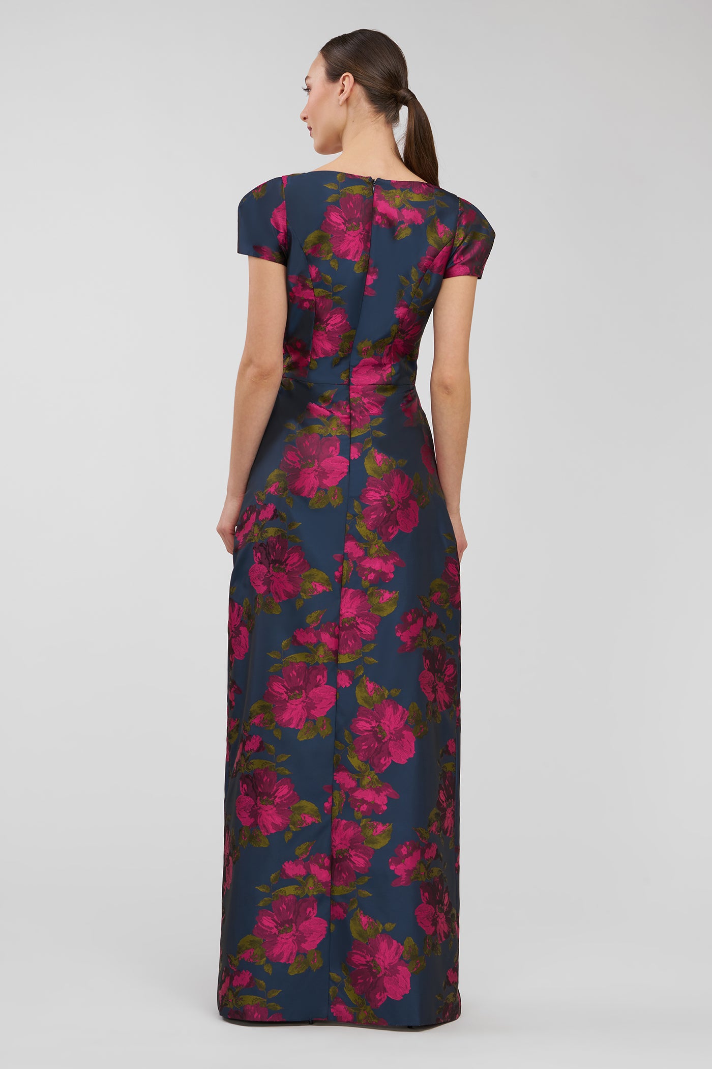 Woman wearing a floral dress on a plain background