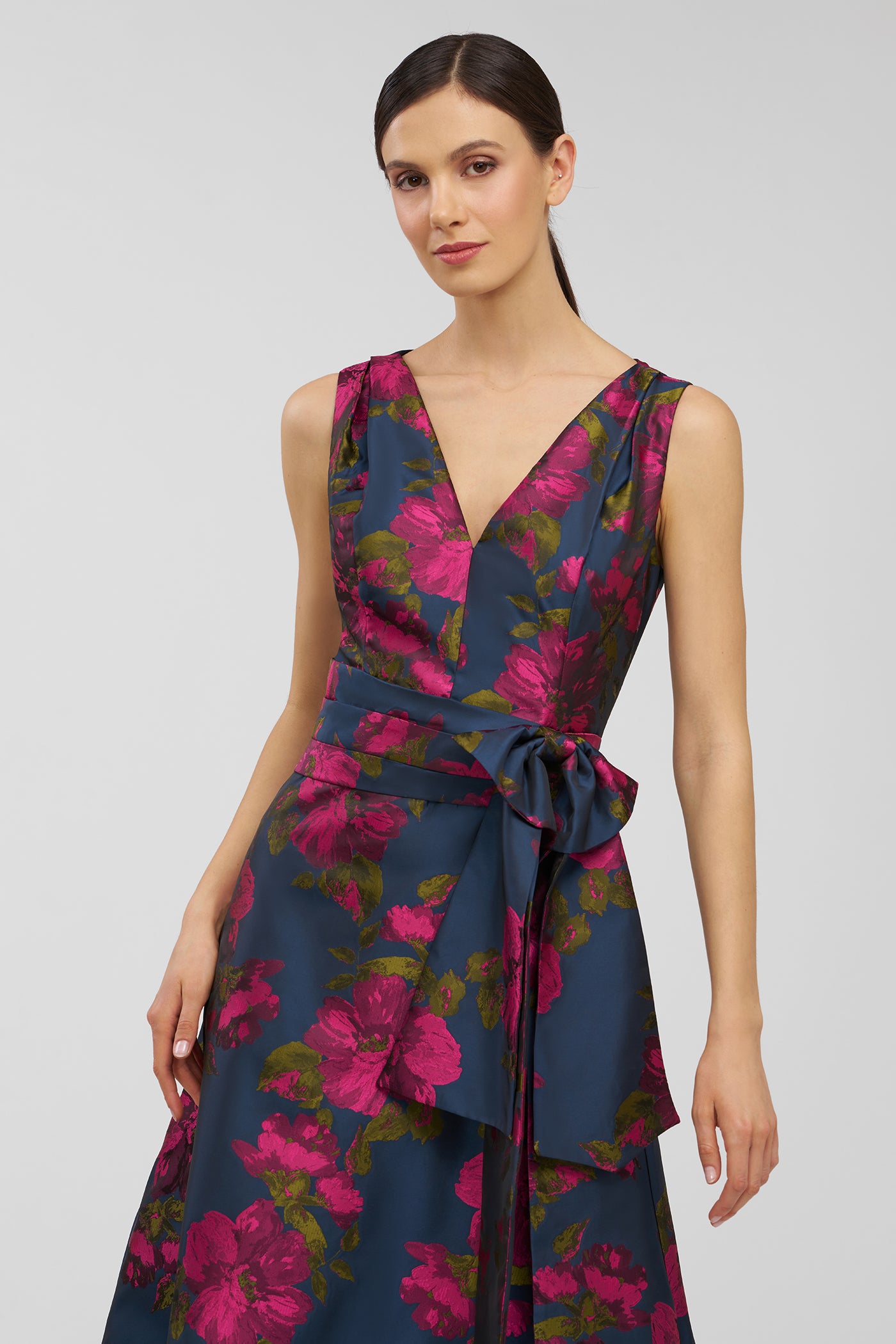 Woman wearing a floral dress with a plain background