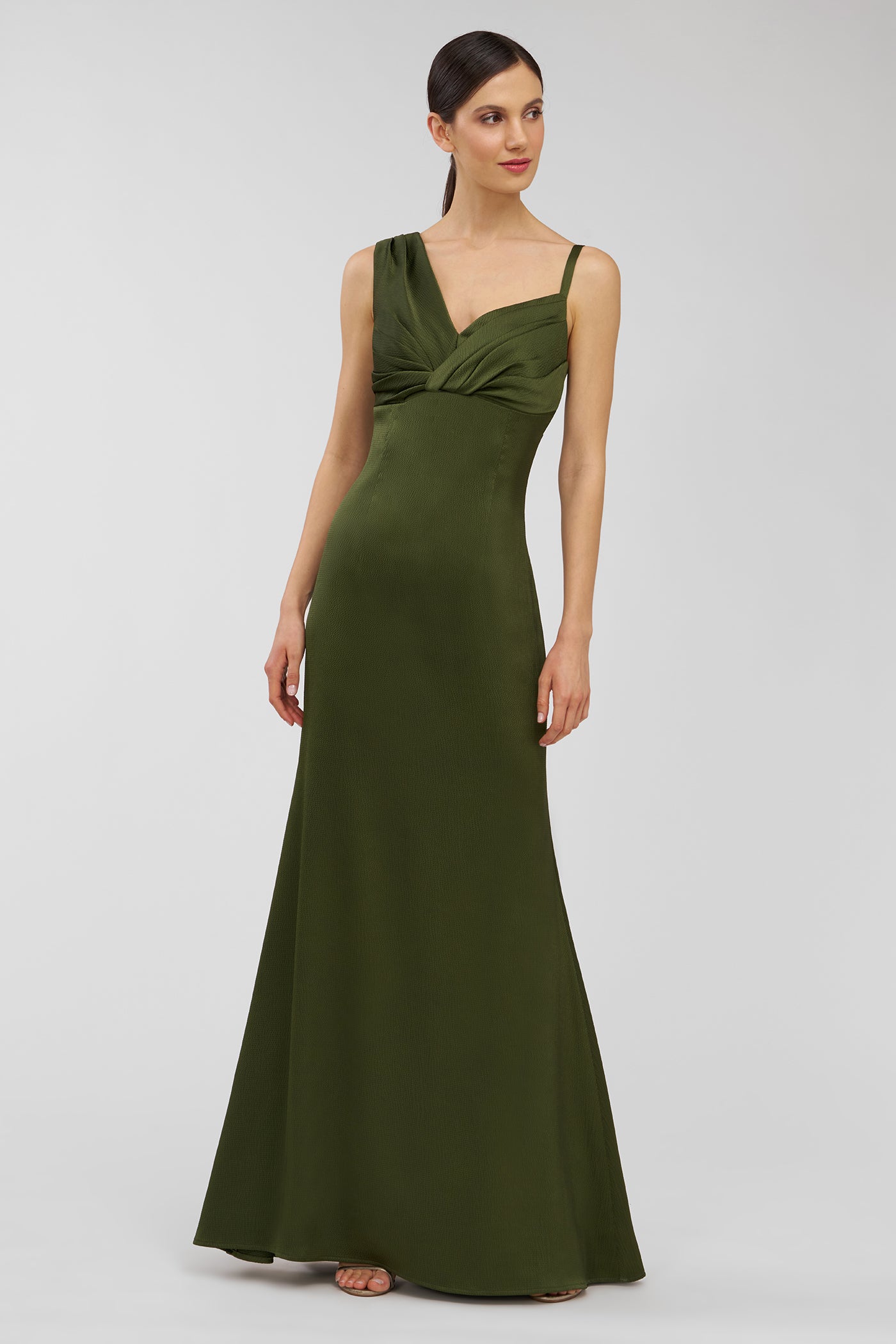 Woman wearing a green evening gown on a white background