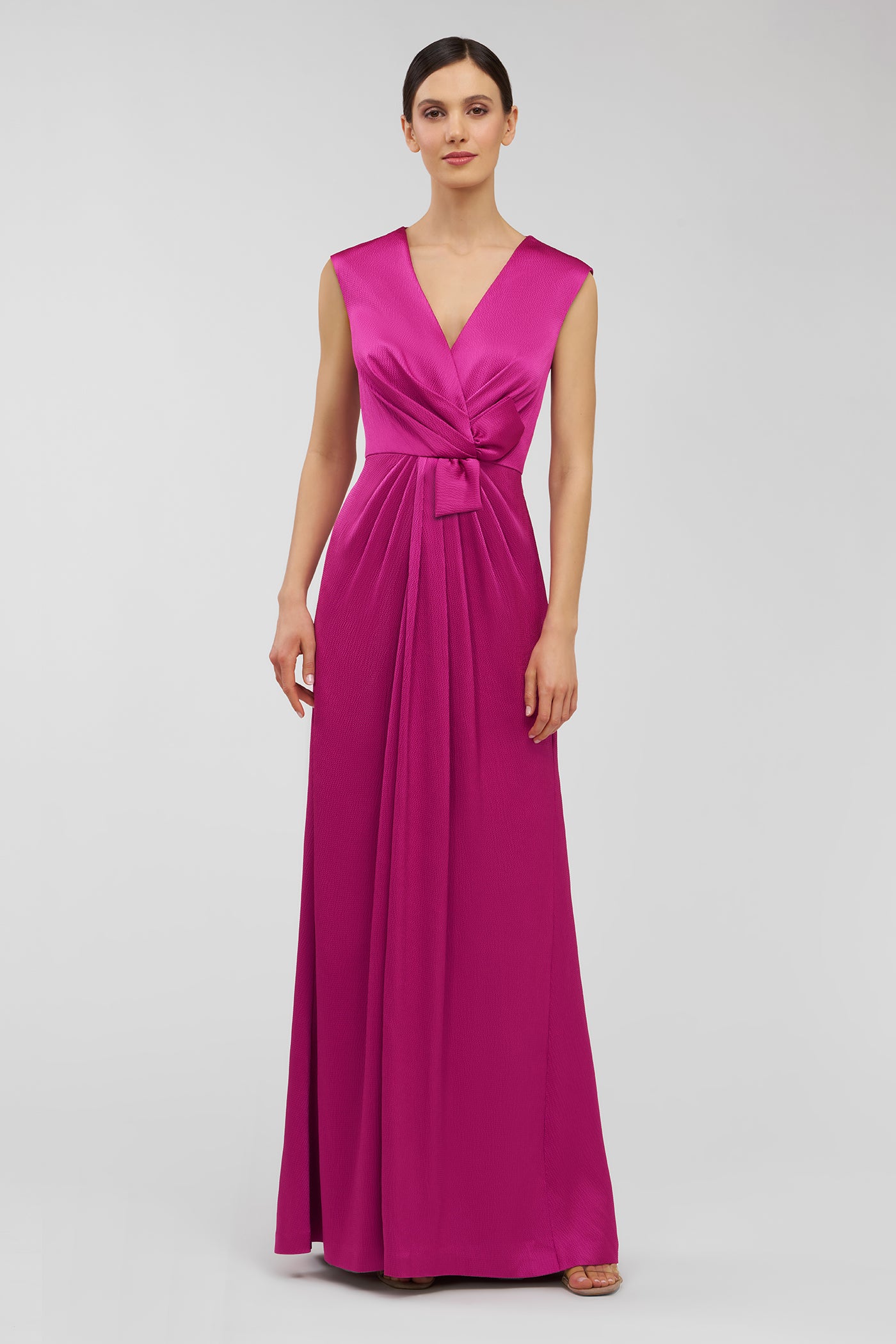 Woman wearing a pink sleeveless gown on a white background