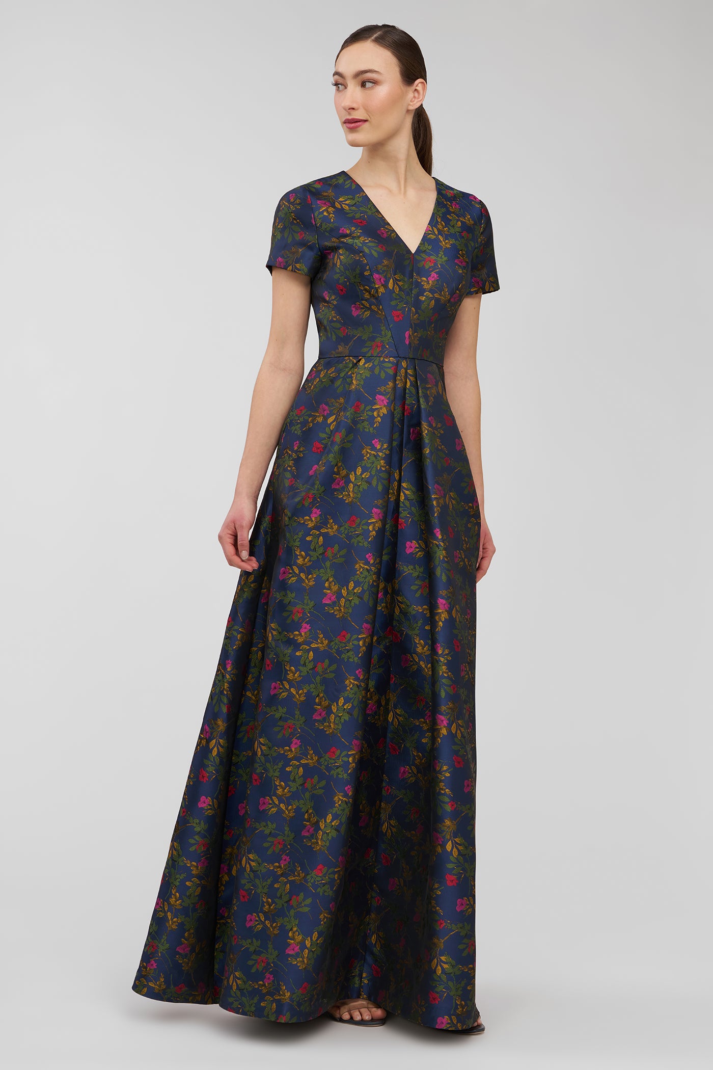 Woman wearing a floral patterned dress on a white background