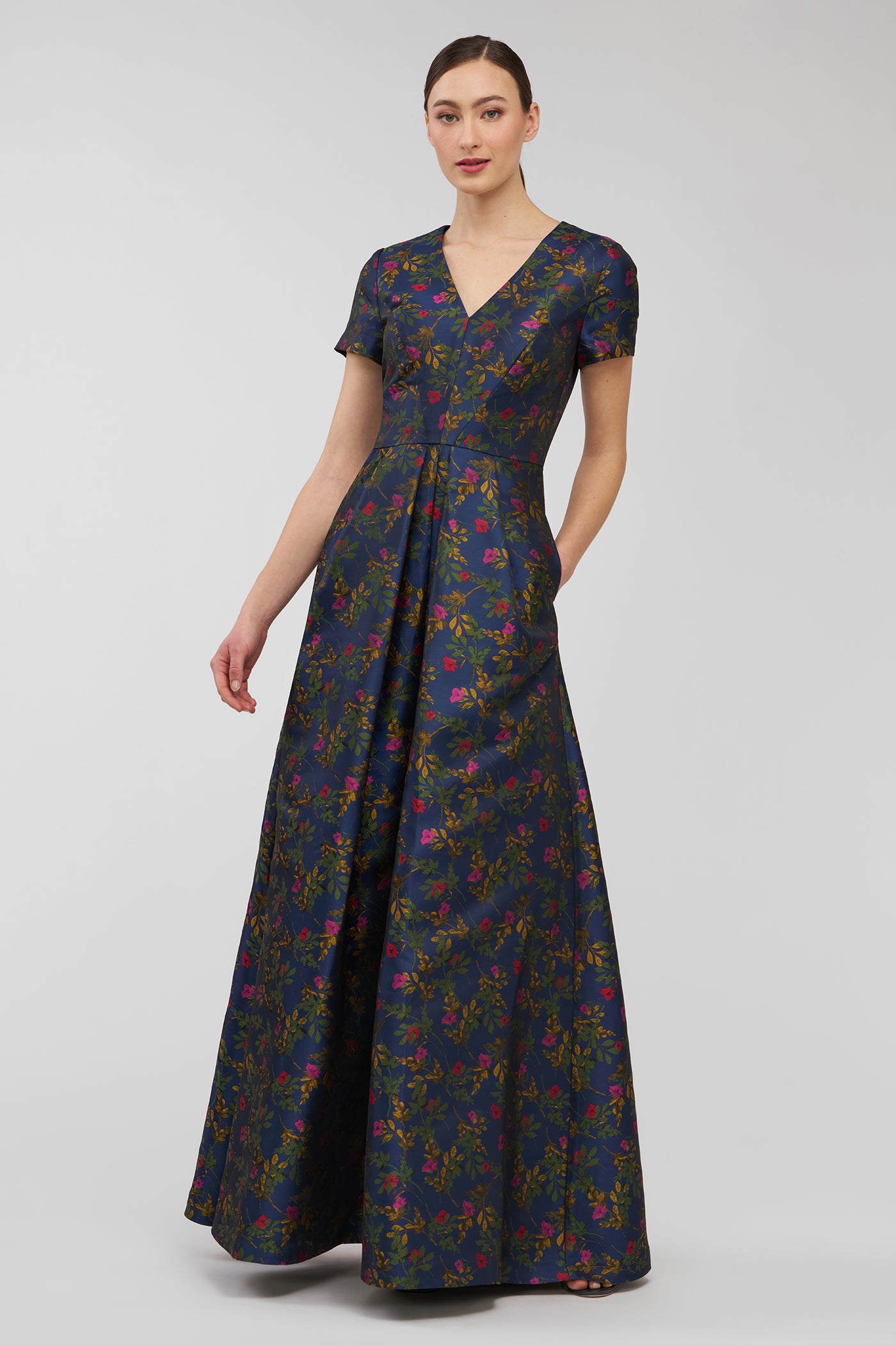 Woman wearing a floral-patterned dress on a white background