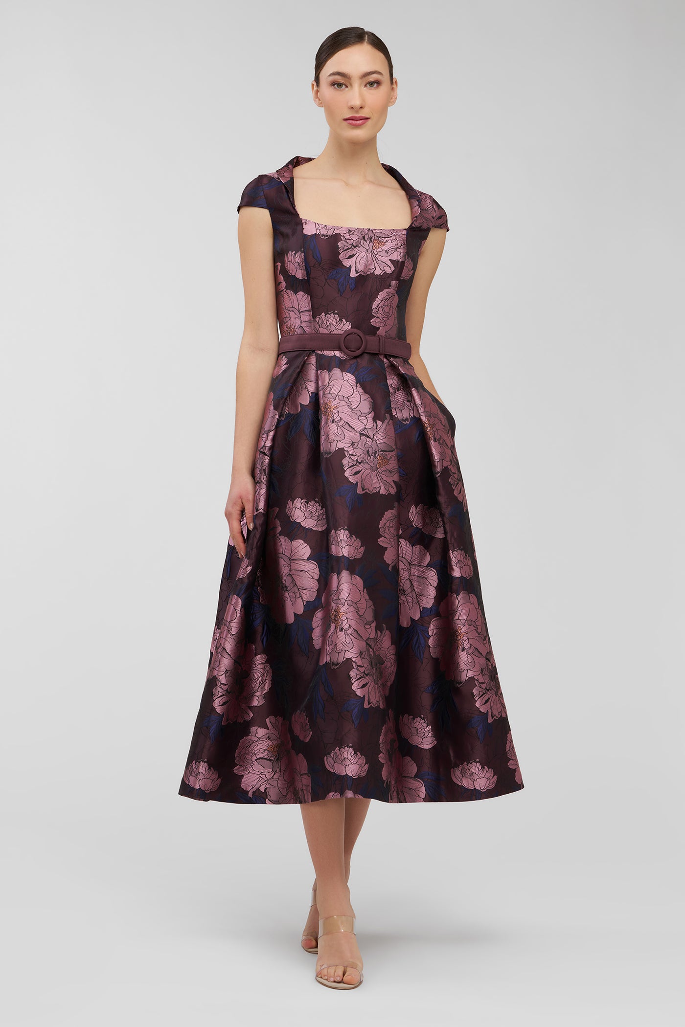 Woman wearing a floral dress on a white background