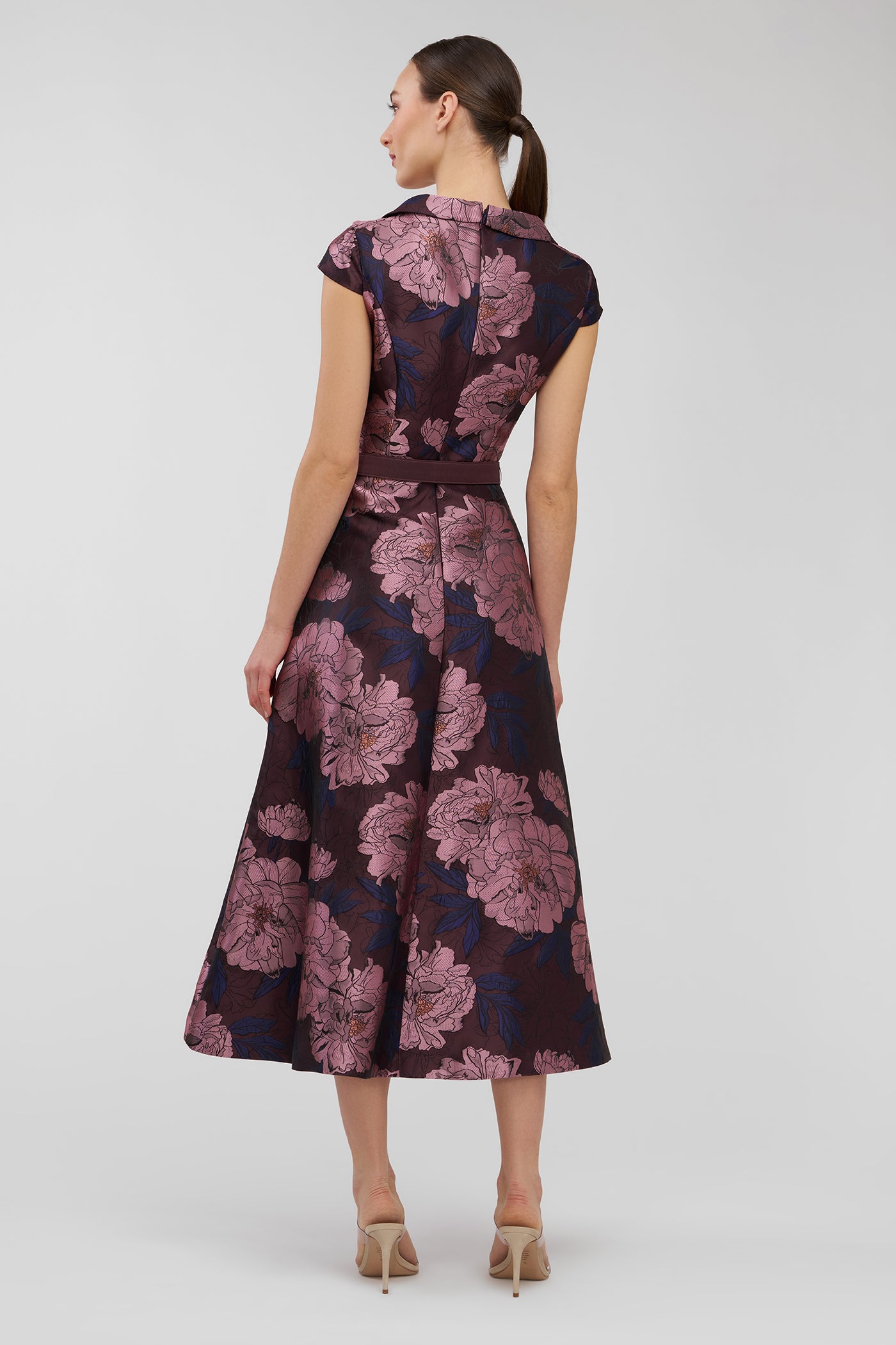 Woman wearing a floral dress on a white background