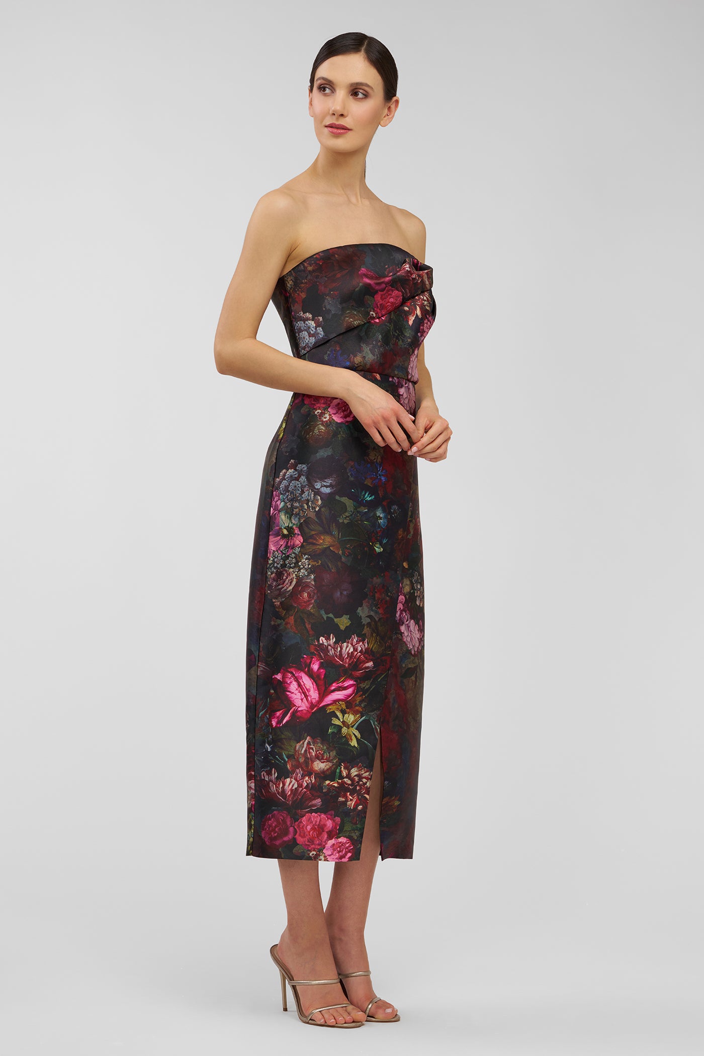 Woman wearing a strapless floral dress on a white background