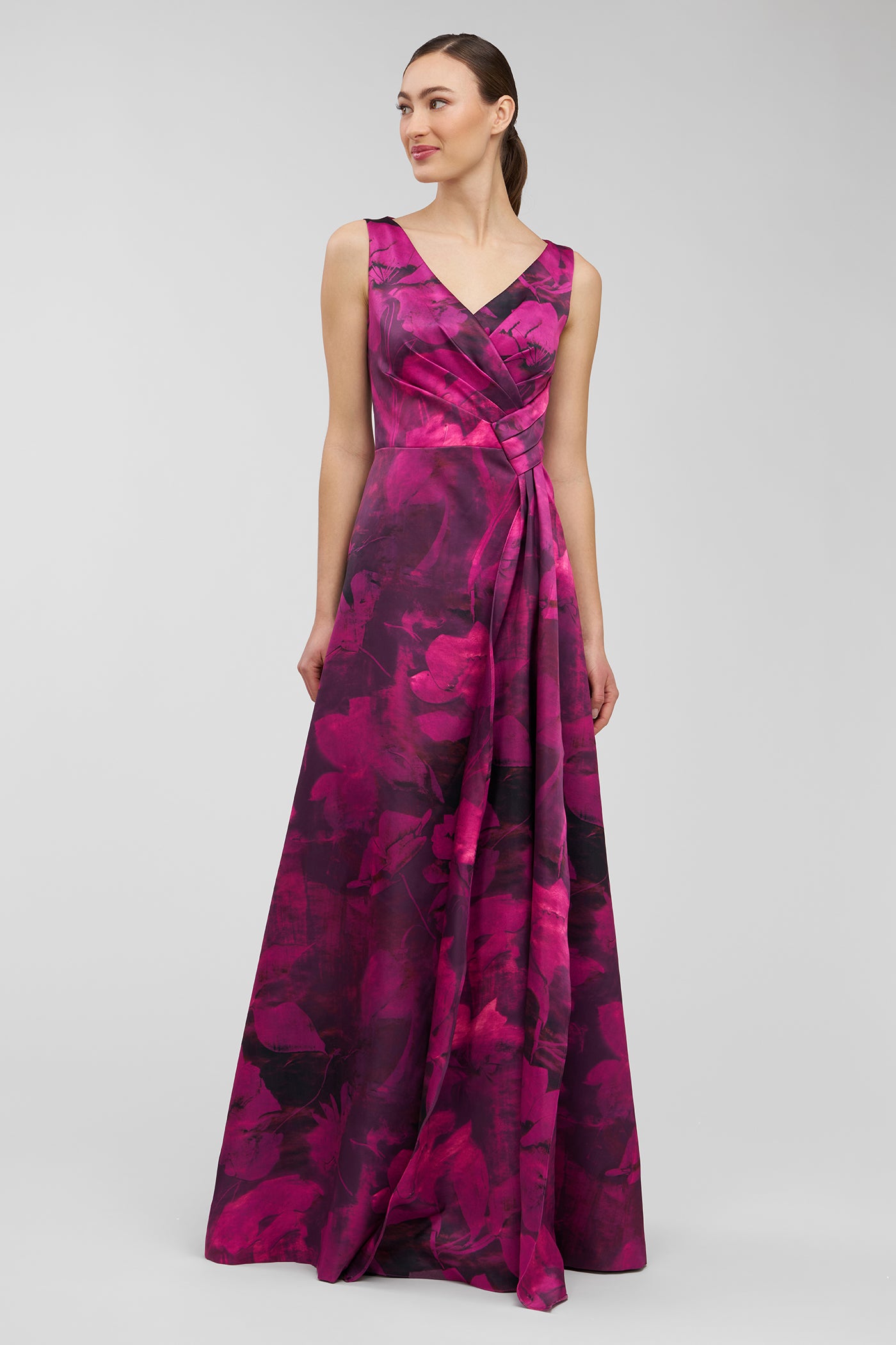 Woman wearing a pink and purple patterned dress on a white background