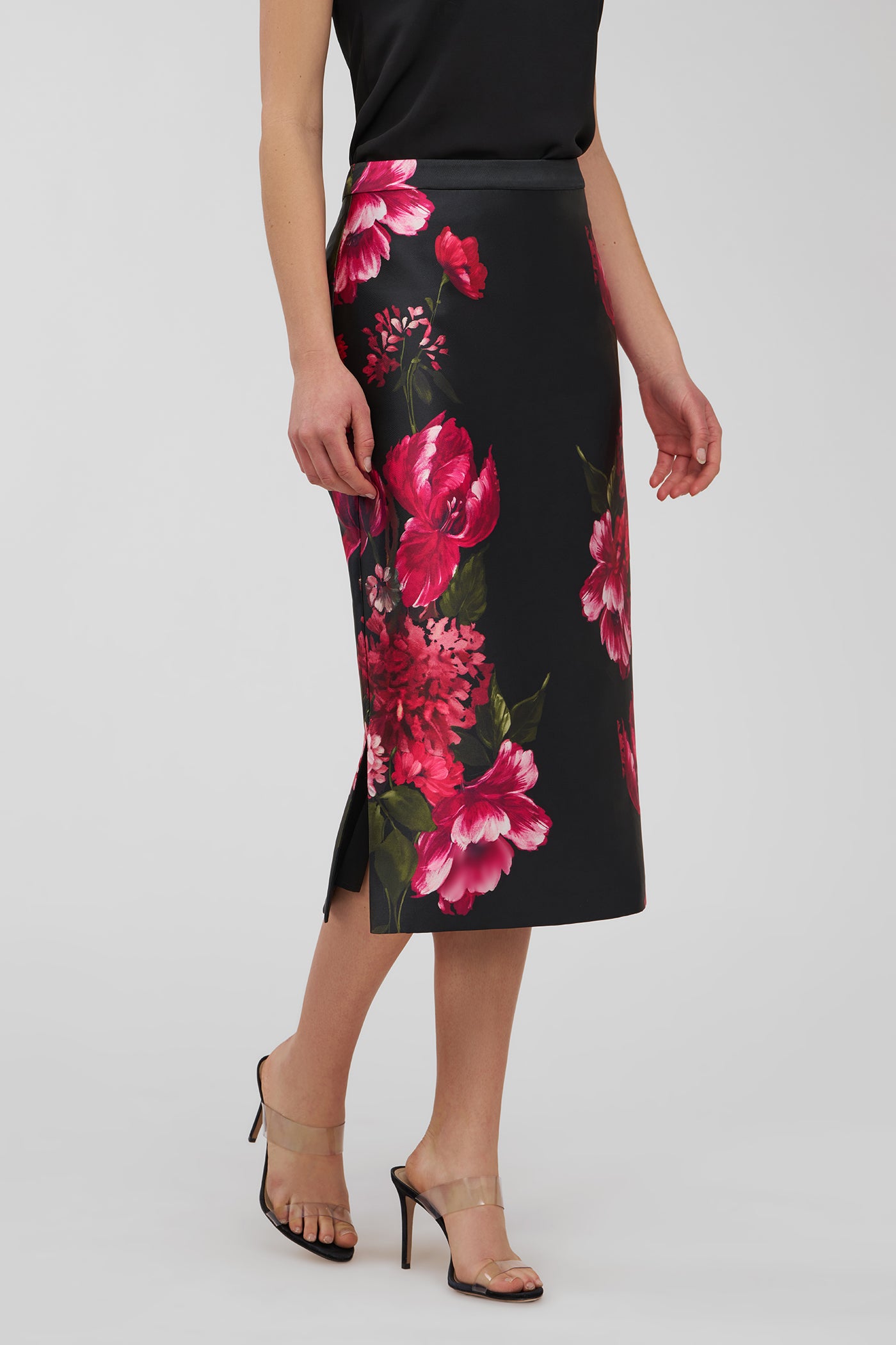 Woman wearing a black floral pencil skirt on a white background